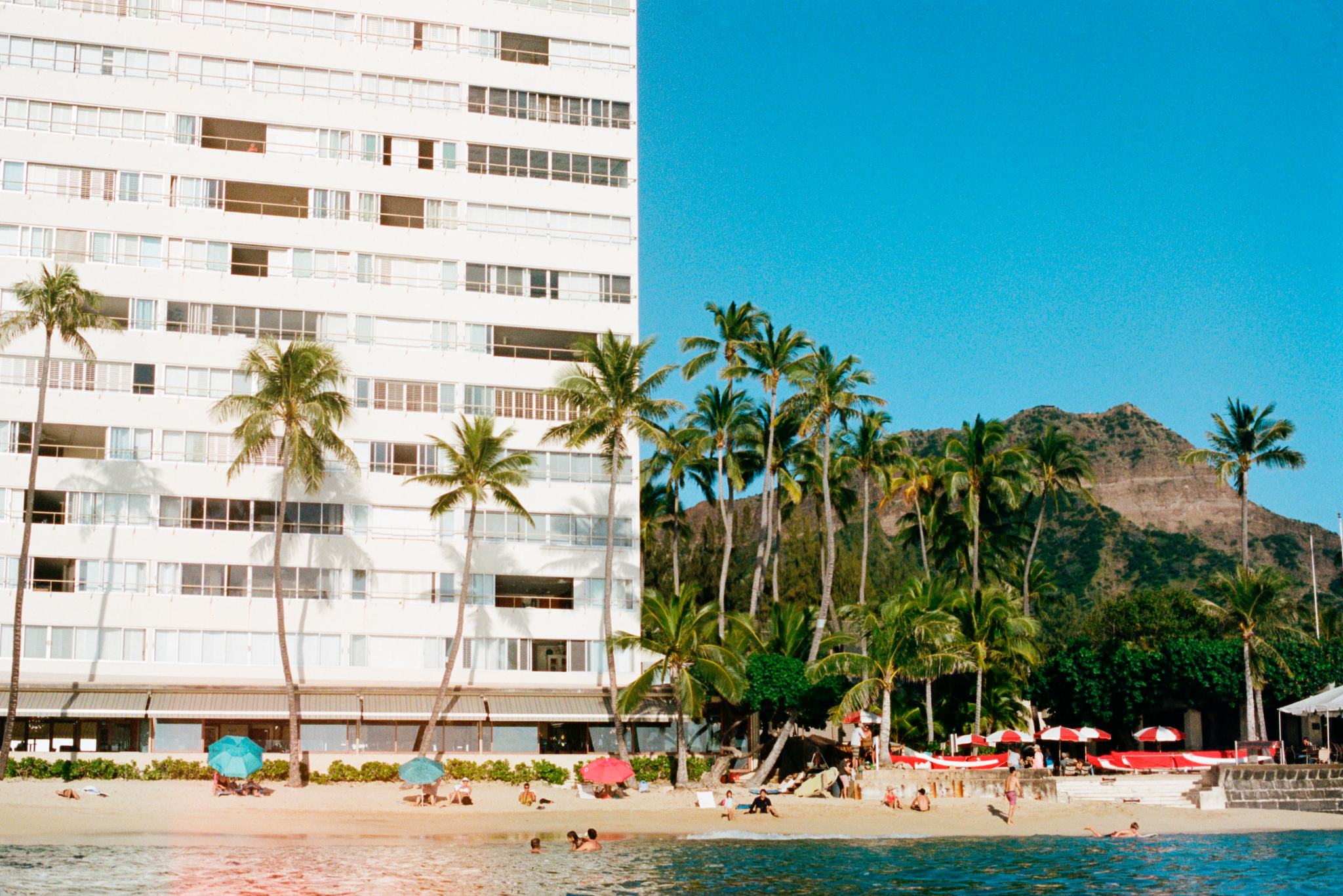 Kaimana beach shot from the water looking at the palms and hotel