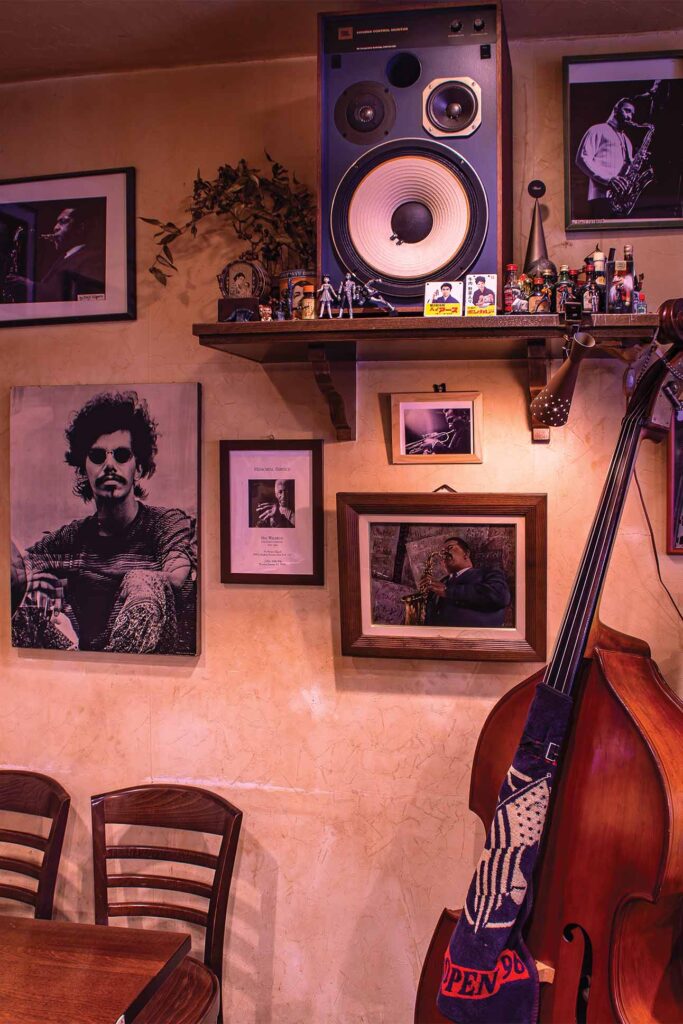 a room with a guitar and pictures on the wall