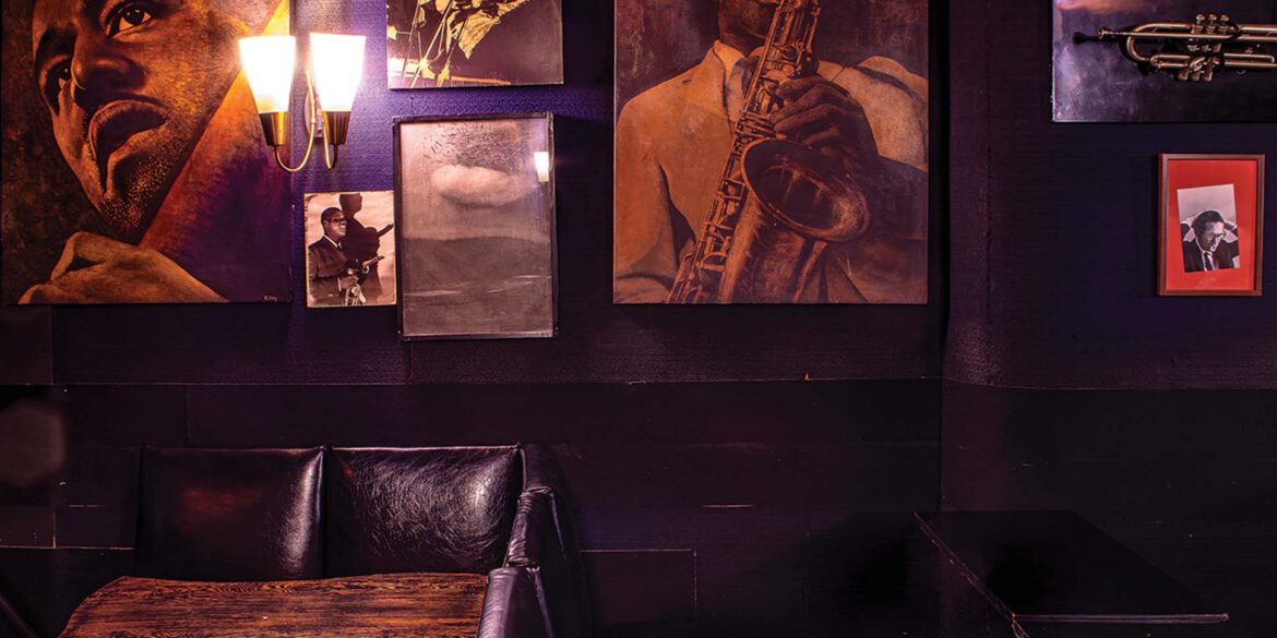a room with a table and a table and a picture of a person playing a saxophone