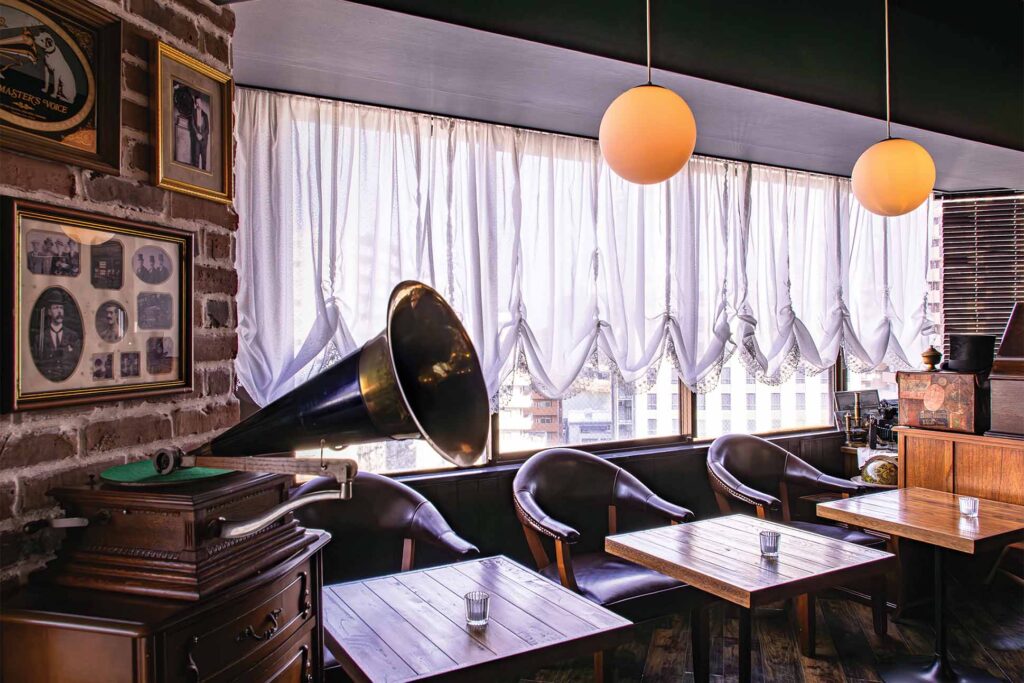 a room with tables and chairs and a gramophone