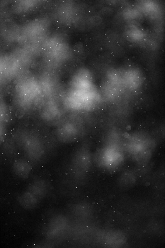 a black and white photo of a dark sky