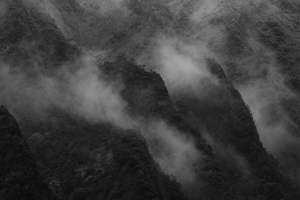 fog covering a mountain with clouds